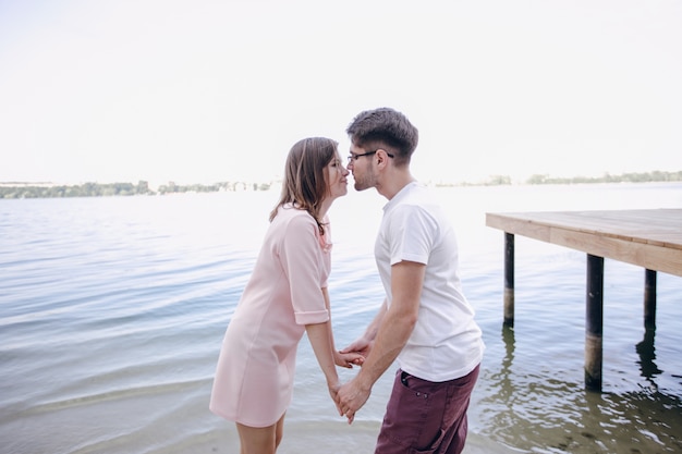 Couple holding hands with sea background
