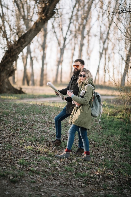 Free photo couple holding map full shot