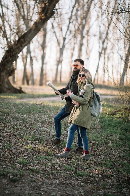 Couple holding map full shot