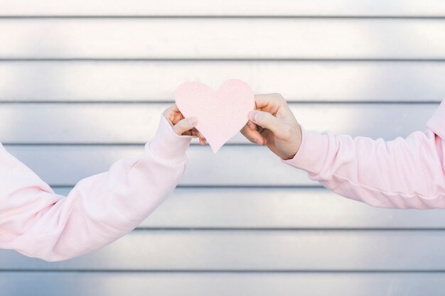Couple holding paper decorative symbol of heart
