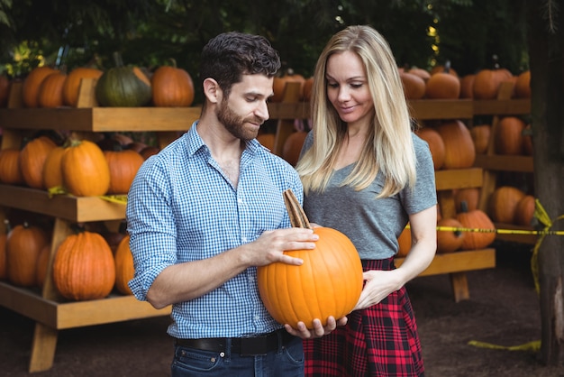 Couple holding pumpkin
