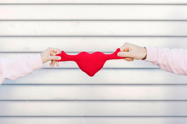 Couple holding toy symbol of heart