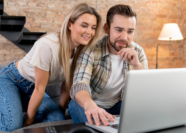 Couple at home having videocall with family