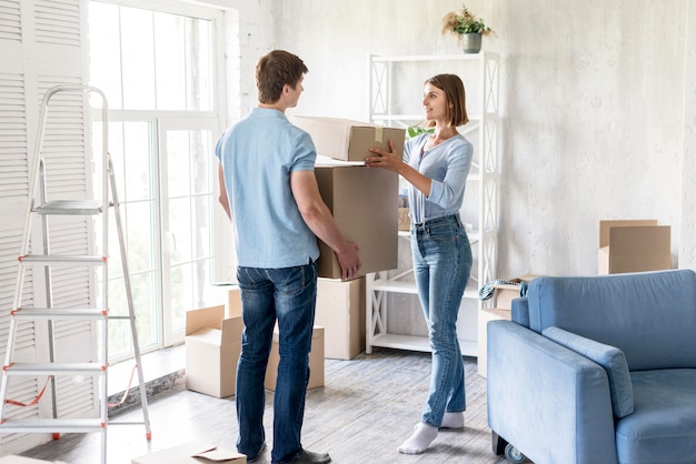 Couple at home preparing boxes to move out