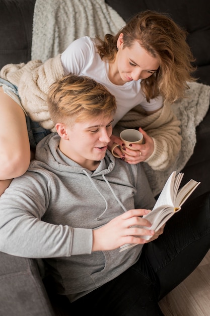 Free photo couple at home reading together