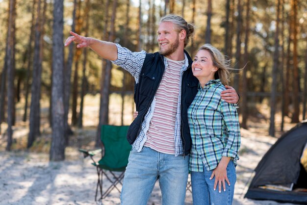 Couple hugging and man pointing his finger