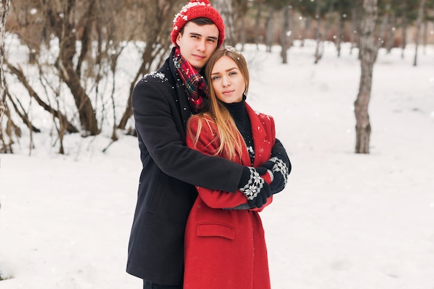 Couple hugging on a snowy day