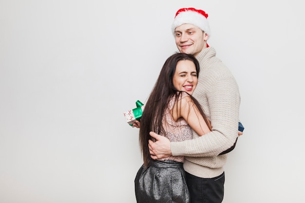 Couple hugging with present boxes