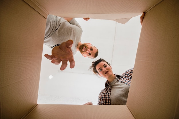 Couple inspecting carton box