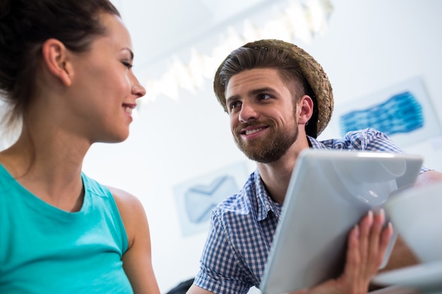 Couple interacting while using digital tablet