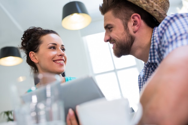 Couple interacting while using digital tablet