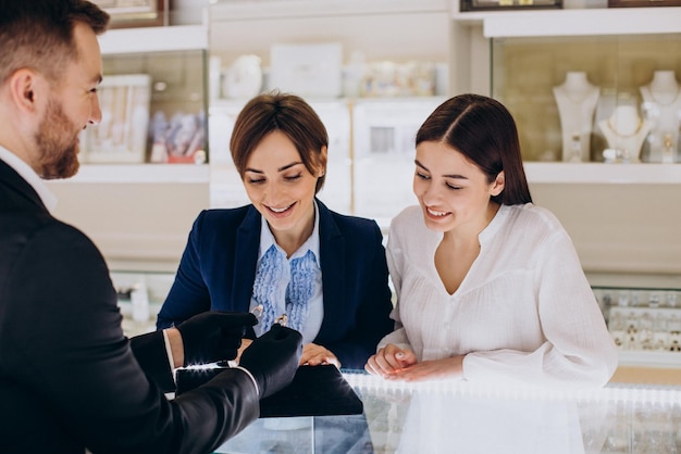 Couple at jewelry store choosing a ring together