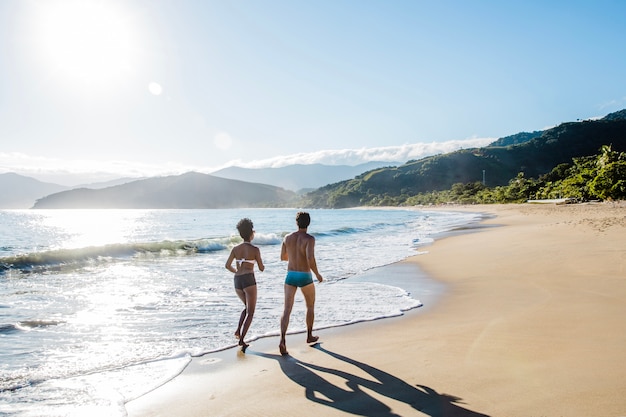 Couple jogging along the shoreline