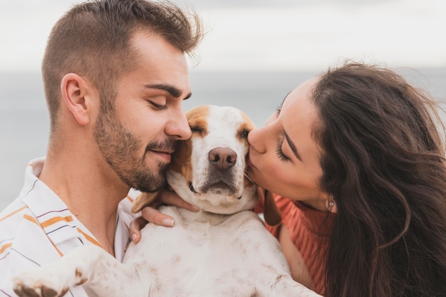 Couple kissing dog