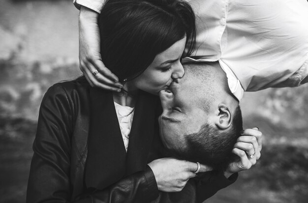 Couple kissing him from above and her from below