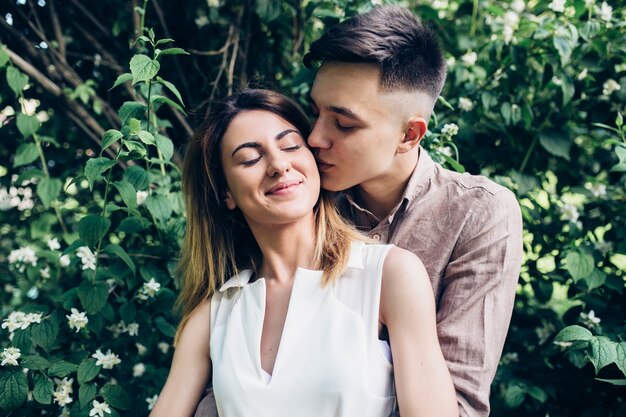 Couple kissing in park green