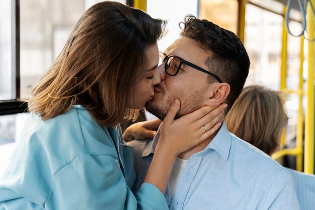 公共交通機関の側面図でキスするカップル