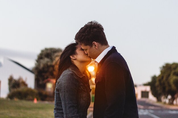 Couple kissing at sunset