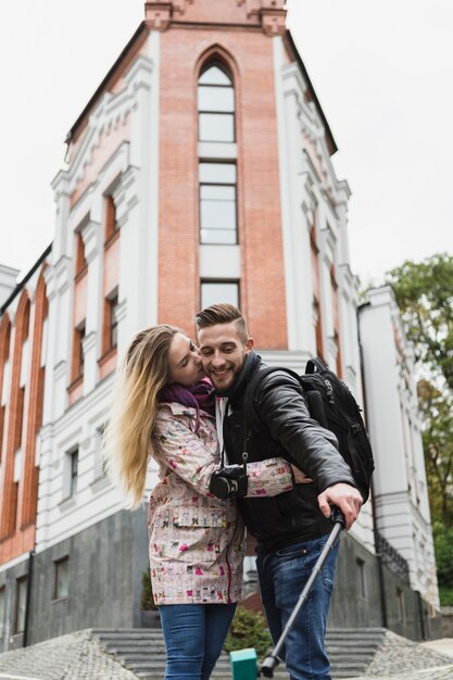 Couple kissing and taking selfie