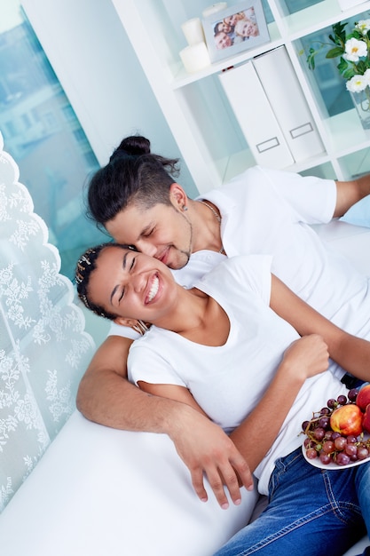 Couple laughing on the couch