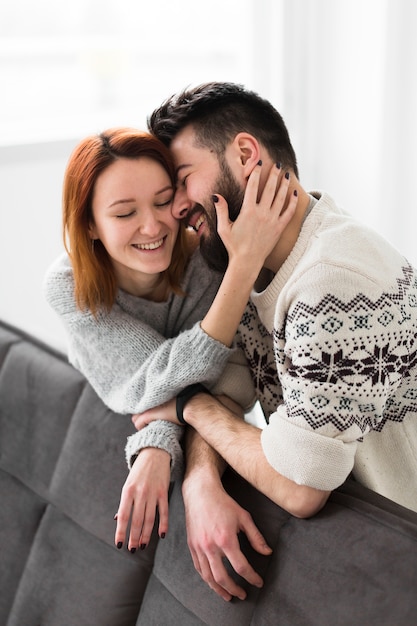 Couple leaning on couch in living room