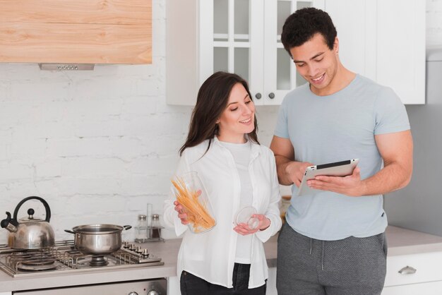 Couple learning how to cook from online courses