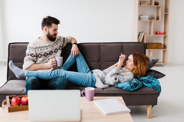 Couple in living room drinking coffee