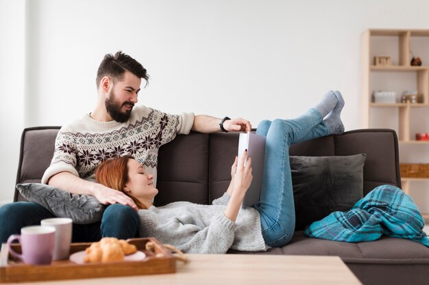 Couple in living room looking at a book