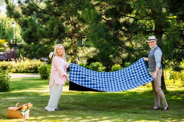 Couple looking at camera while holding a blanket