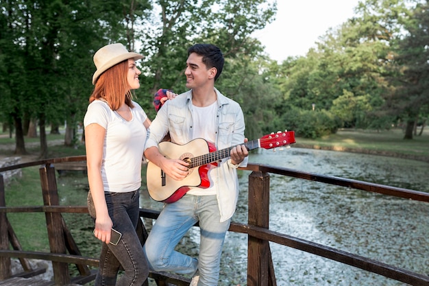 Couple looking at each other at a bridge 