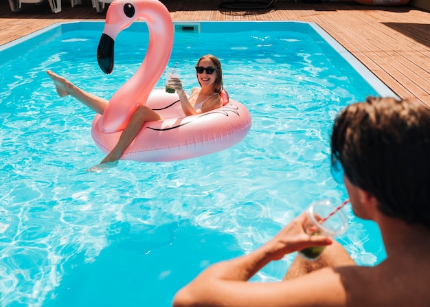 Couple looking at each other in pool