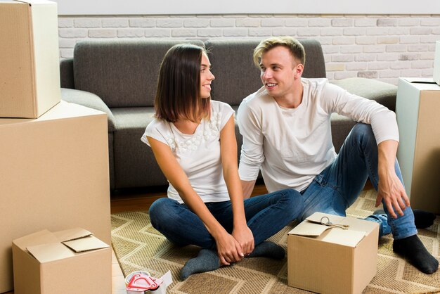 Free photo couple looking at each other while packing