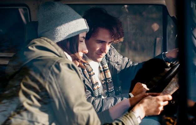 Couple looking at a map while road tripping