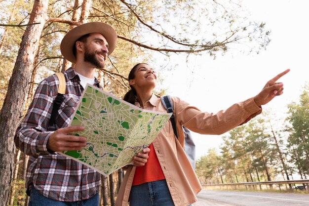 Couple looking in the same directions while man is holding a map