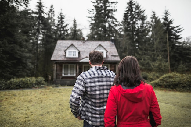 Free photo couple looking at shack