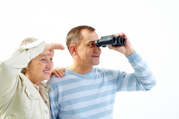 Couple looking at the sky with their binoculars