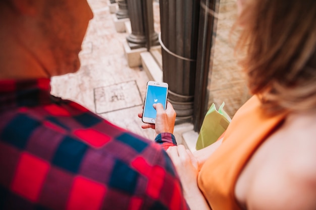 Free photo couple looking at smartphone