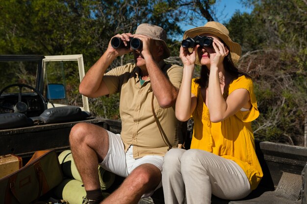 Couple looking through binoculars