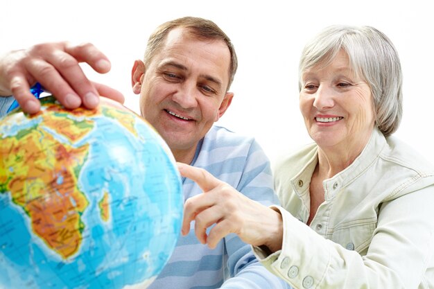 Couple looking the world map for the next trip