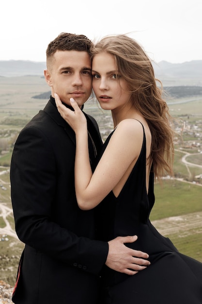 Free photo couple in love in black dress and suit