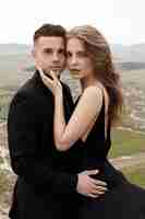 Free photo couple in love in black dress and suit