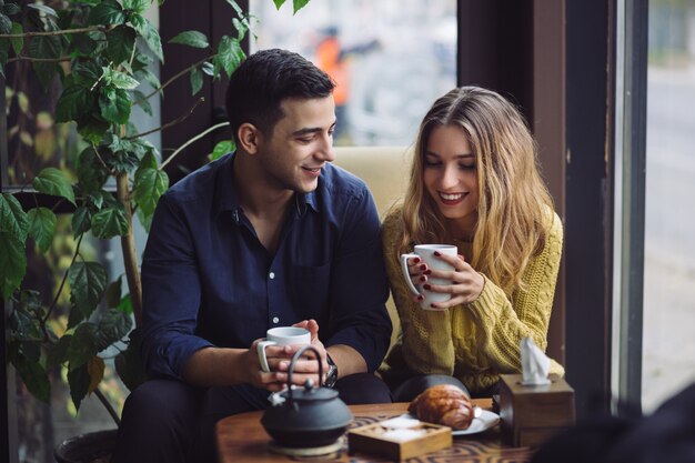 Couple in love drinking coffee in coffee shop