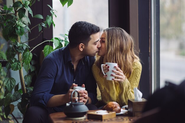 Couple in love drinking coffee in coffee shop