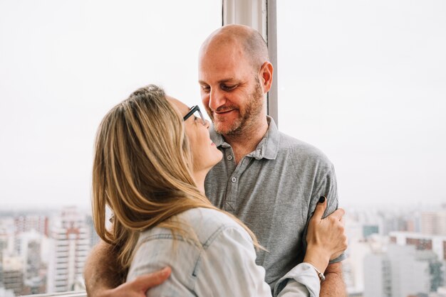 Couple in love in front of window