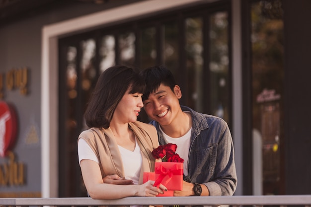 Free photo couple in love holding a red gift