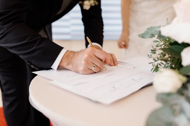 Free photo couple in love is signing official marriage documents