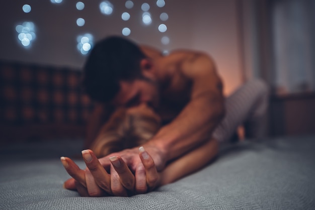 Couple in love kissing on the bed at home