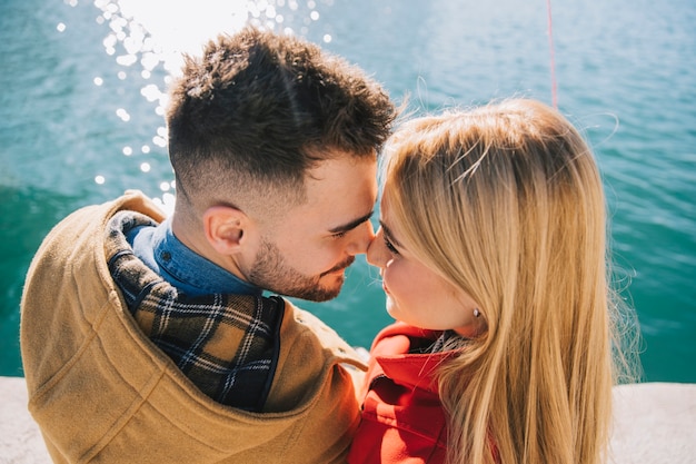 Free photo couple in love posing on seafront