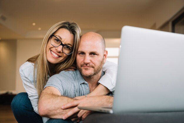 Free photo couple in love using laptop