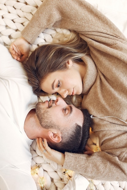 Couple lying on a bed in a room